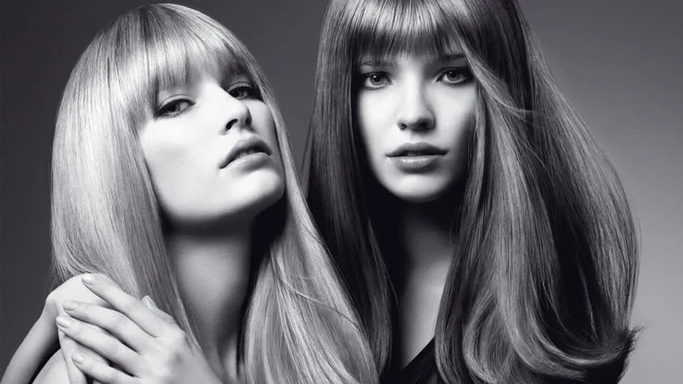 Two models with long, glossy blow-dried hair, photographed for a Roi Hair campaign
