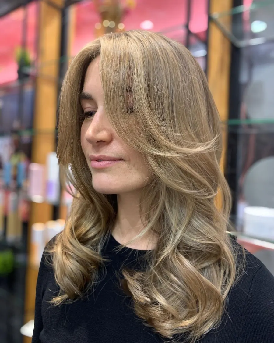 Warm blonde layers toned evenly with no visible banding, by Roi Hair