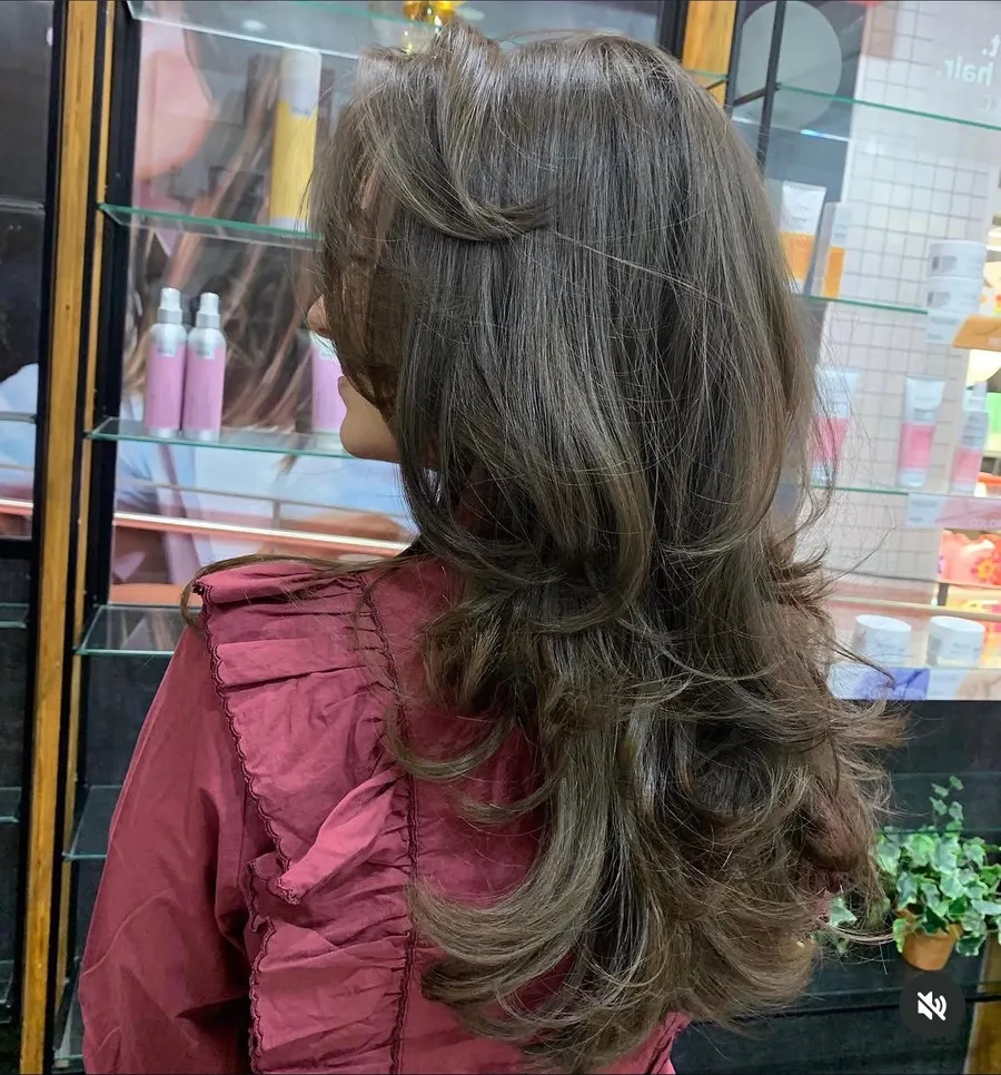 Long brunette layers blow-dried into a soft curl, cut and styled at Roi Hair