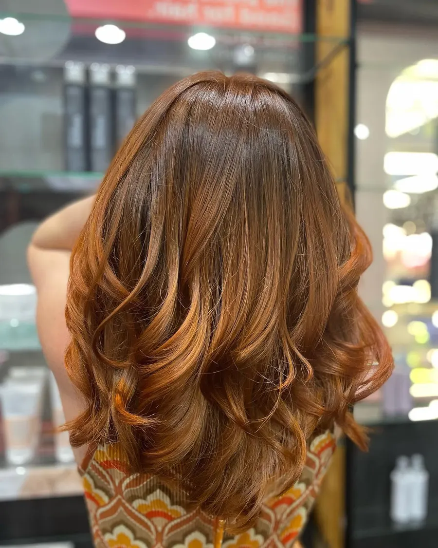 Long copper waves blow-dried out, coloured and finished at Roi Hair
